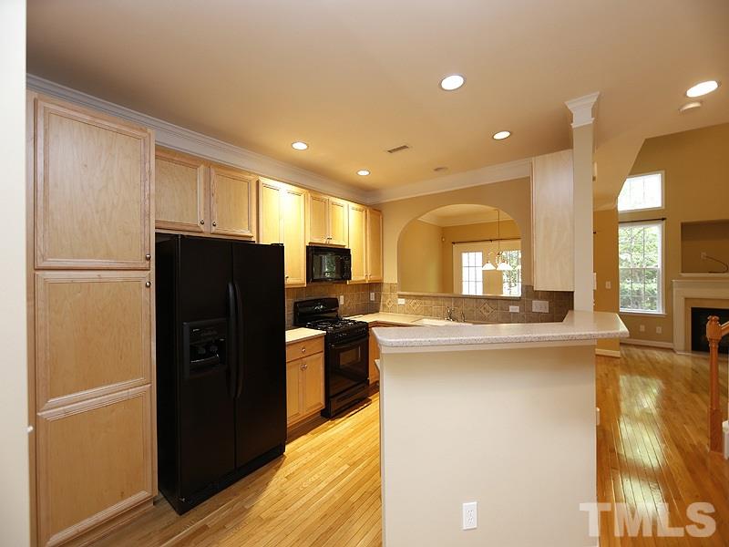 5947 Four Townes Lane Raleigh, NC 27616 - Photo 2 of 12 a kitchen with stainless steel appliances granite countertop a refrigerator a stove a sink and a refrigerator