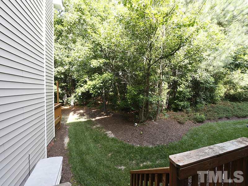 5947 Four Townes Lane Raleigh, NC 27616 - Photo 12 of 12 a view of a yard with plants and a bench