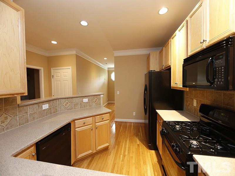 5947 Four Townes Lane Raleigh, NC 27616 - Photo 3 of 12 a kitchen with a sink stove and refrigerator