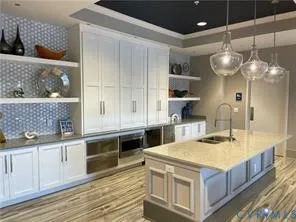 a kitchen with stainless steel appliances granite countertop a sink and a stove