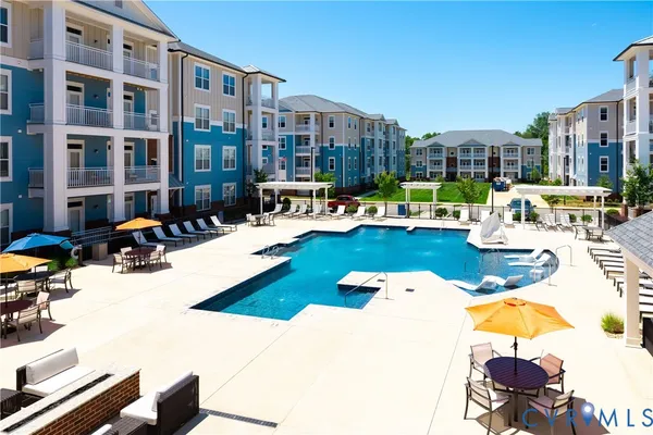 a view of a swimming pool and lounge chairs