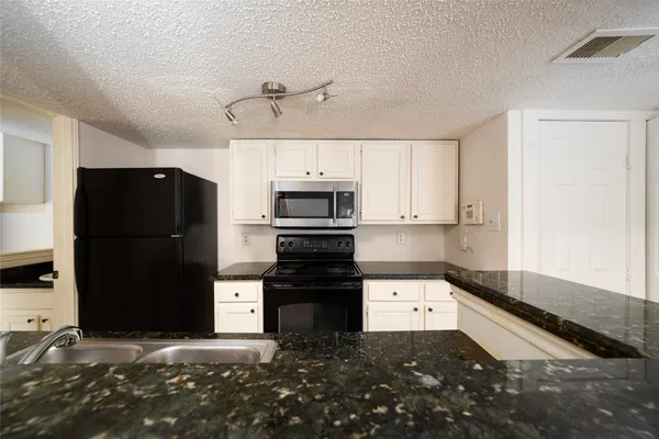 a kitchen that has a sink and a stove