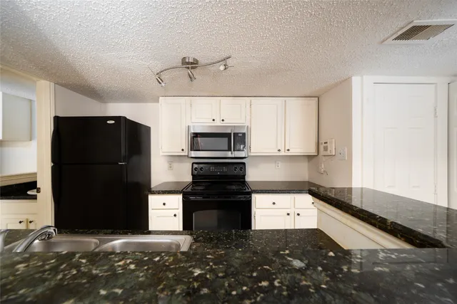 a kitchen that has a sink and a stove