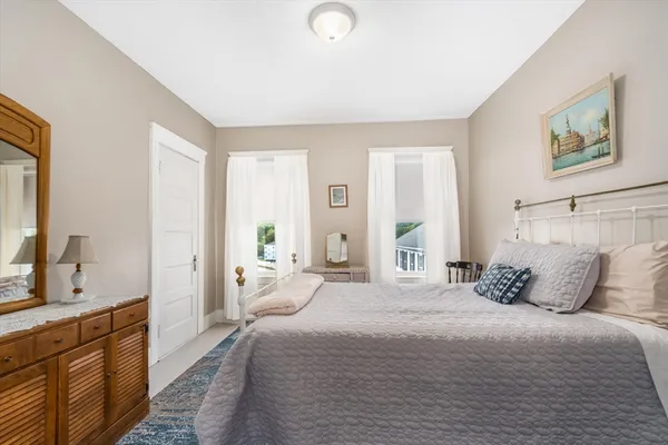 a bedroom with a large bed and a large window