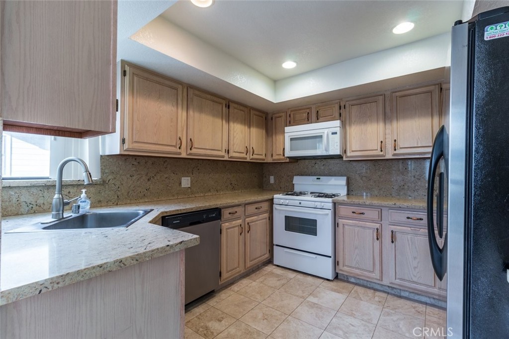 514 North Isabel Street, Unit C Glendale, CA 91206 - Photo 11 of 36 a kitchen with stainless steel appliances granite countertop a sink and stove top oven