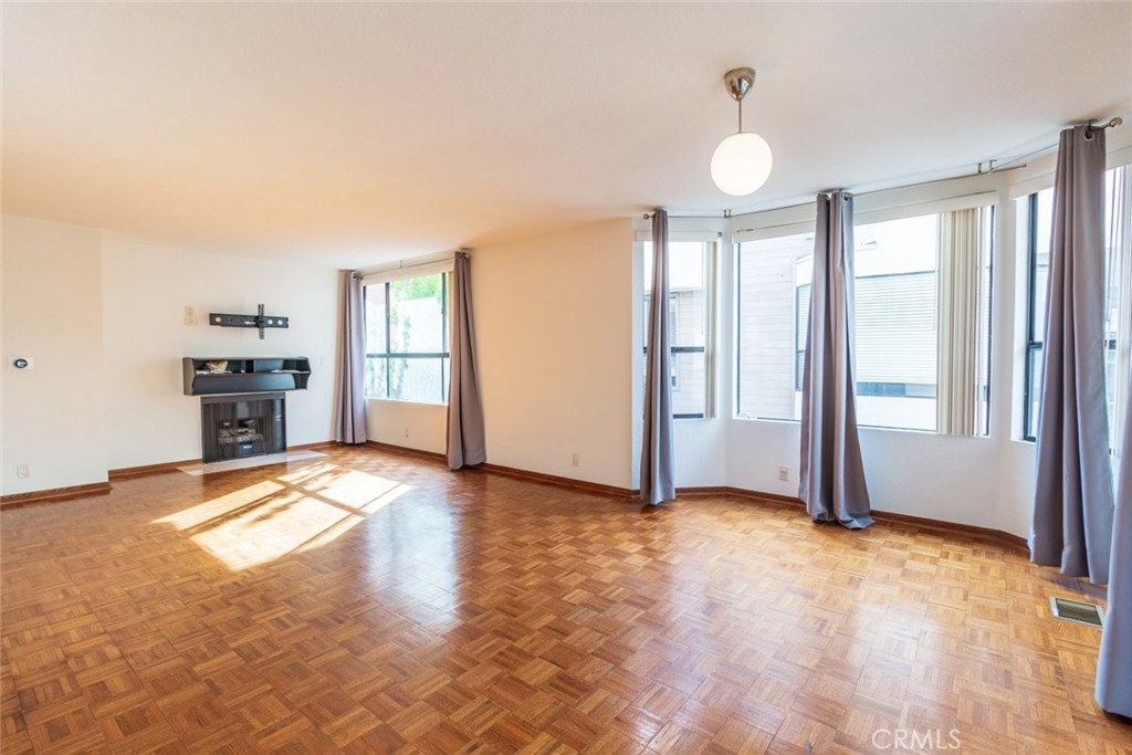 514 North Isabel Street, Unit C Glendale, CA 91206 - Photo 13 of 36 a view of empty room with wooden floor and window