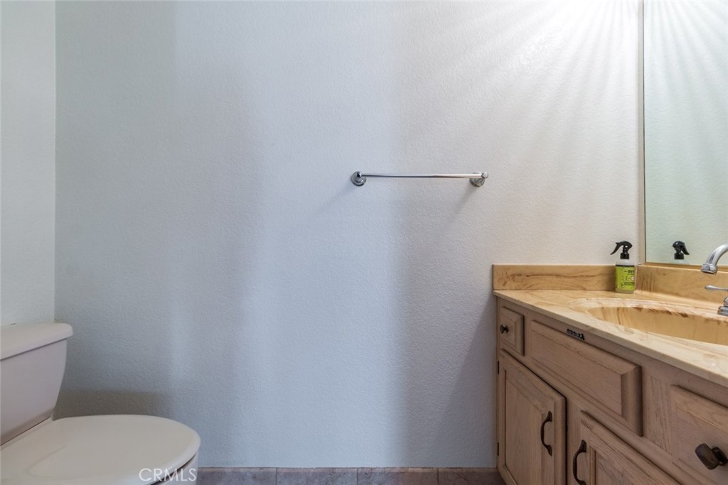 514 North Isabel Street, Unit C Glendale, CA 91206 - Photo 14 of 36 a bathroom with a granite countertop toilet sink and mirror