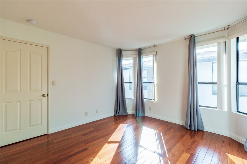 514 North Isabel Street, Unit C Glendale, CA 91206 - Photo 19 of 36 a view of empty room with wooden floor and fan