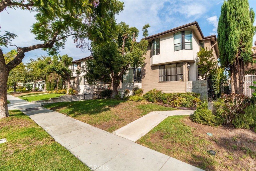 514 North Isabel Street, Unit C Glendale, CA 91206 - Photo 2 of 36 a front view of a house with a yard and a garage