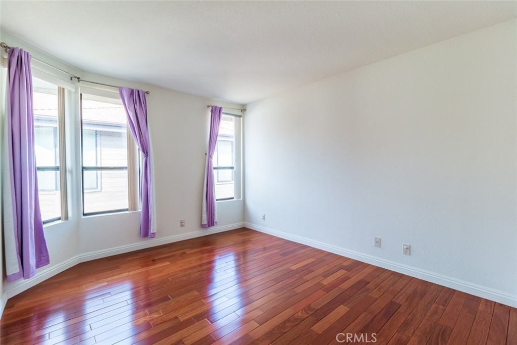 514 North Isabel Street, Unit C Glendale, CA 91206 - Photo 24 of 36 an empty room with wooden floor and windows