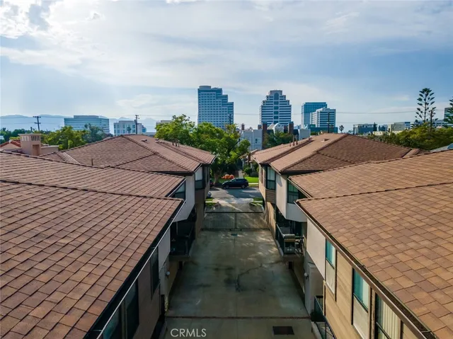 an aerial view of residential houses with outdoor space and street view