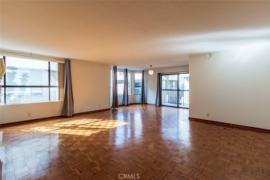 514 North Isabel Street, Unit C Glendale, CA 91206 - Photo 6 of 36 an empty room with wooden floor and windows