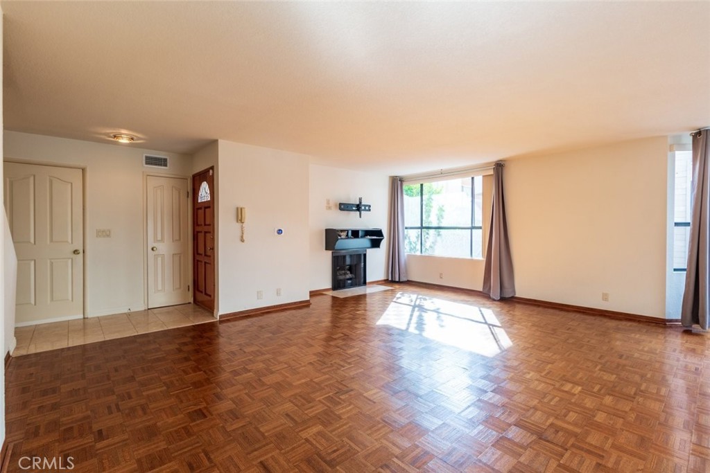 514 North Isabel Street, Unit C Glendale, CA 91206 - Photo 9 of 36 a view of empty room with wooden floor and fan