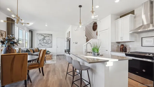 a dining room with furniture and wooden floor