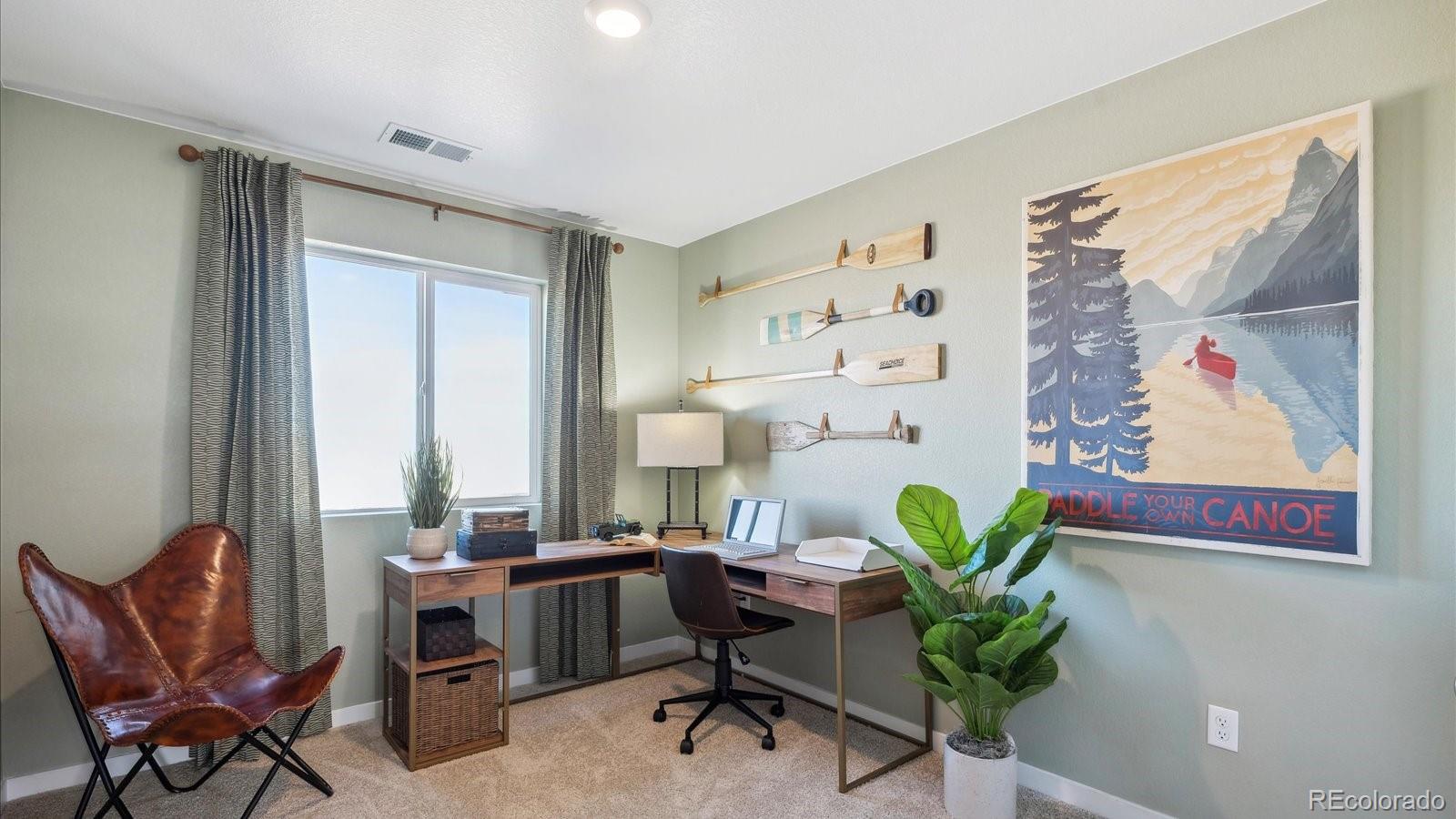 906 Logan Peak Way Berthoud, CO 80513 - Photo 18 of 29 a workspace with furniture and a window