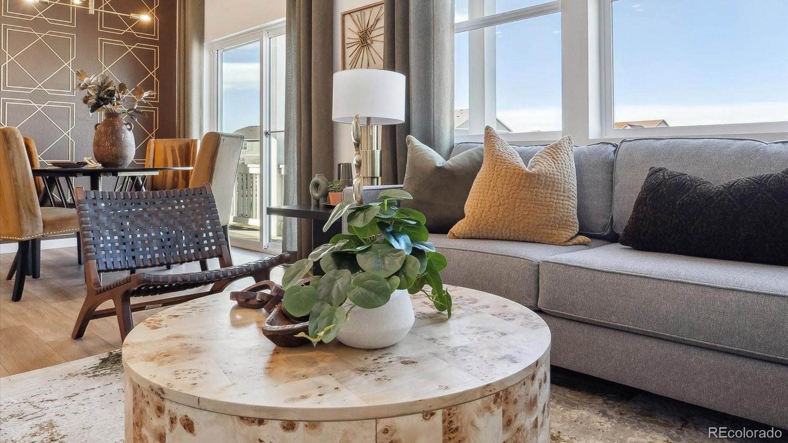906 Logan Peak Way Berthoud, CO 80513 - Photo 4 of 29 a dining room with furniture and wooden floor