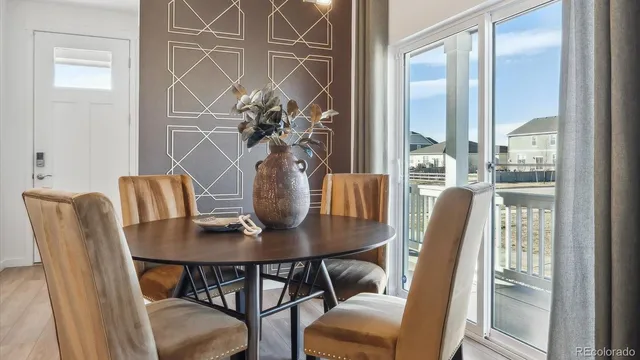 a dining room with furniture and wooden floor