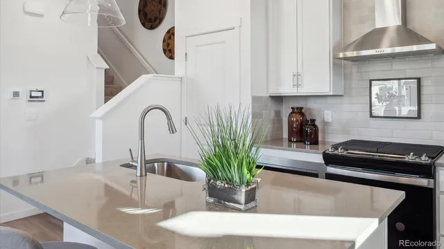 a kitchen with a two sink and a stove with wooden floor