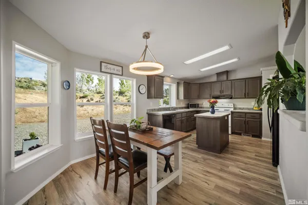 a view of a dining room with furniture window and wooden floor