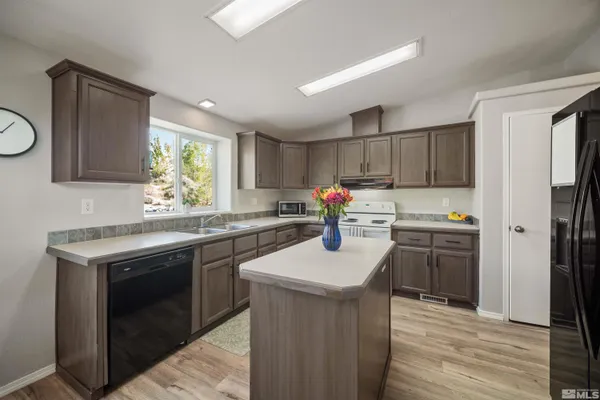 a kitchen with a sink stove and refrigerator