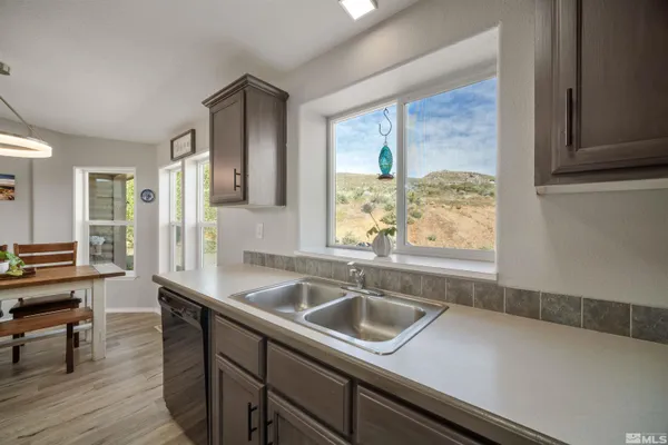 a kitchen with a sink a counter space and dining table