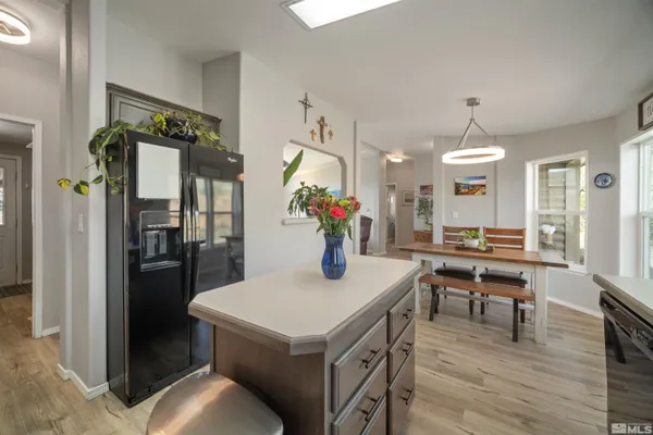 a view of a dining room kitchen with furniture and wooden floor