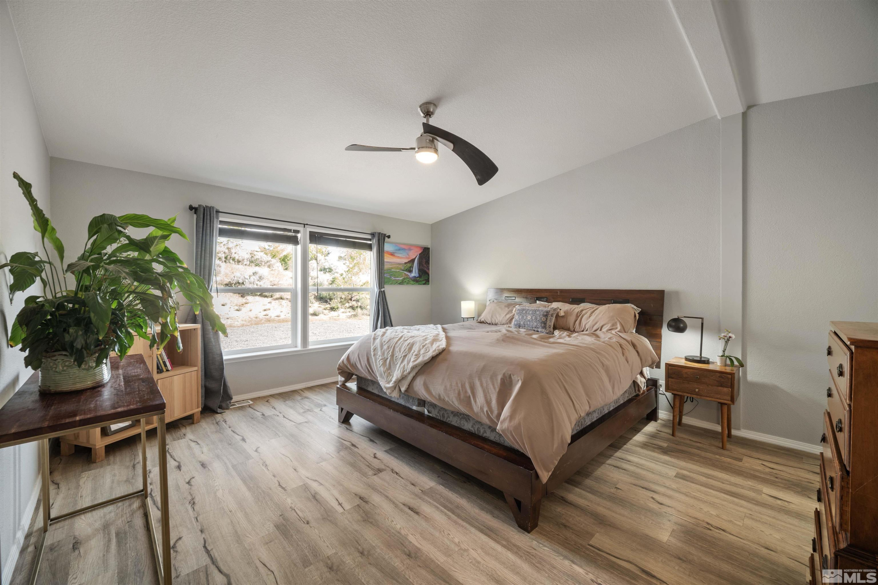13705 North Red Rock Road Reno, NV 89508 - Photo 19 of 46 a bedroom with a bed window and potted plant on table