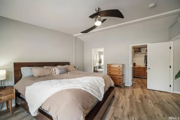 a bedroom with a bed and a large mirror