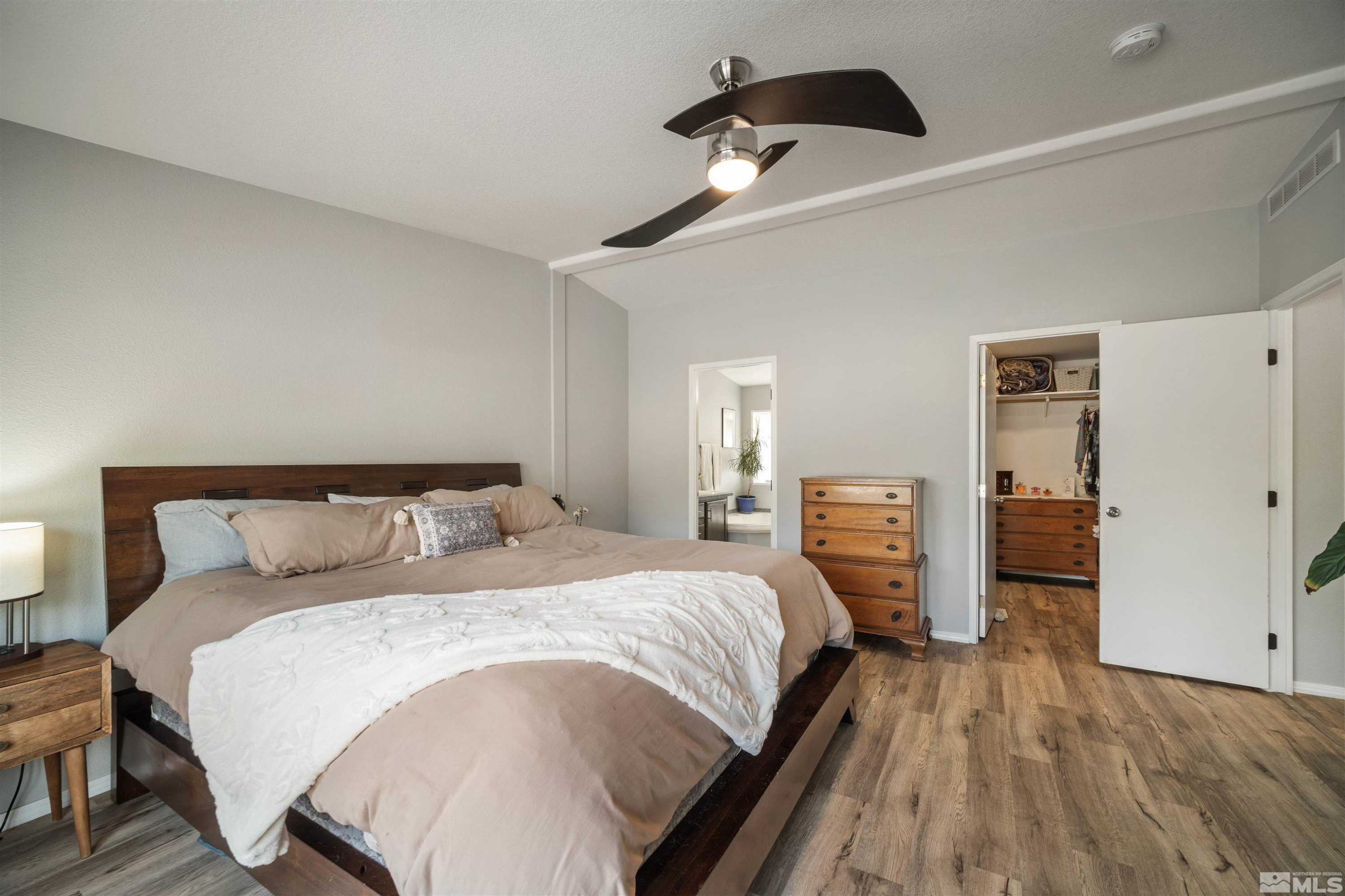 13705 North Red Rock Road Reno, NV 89508 - Photo 20 of 46 a bedroom with a bed and a large mirror