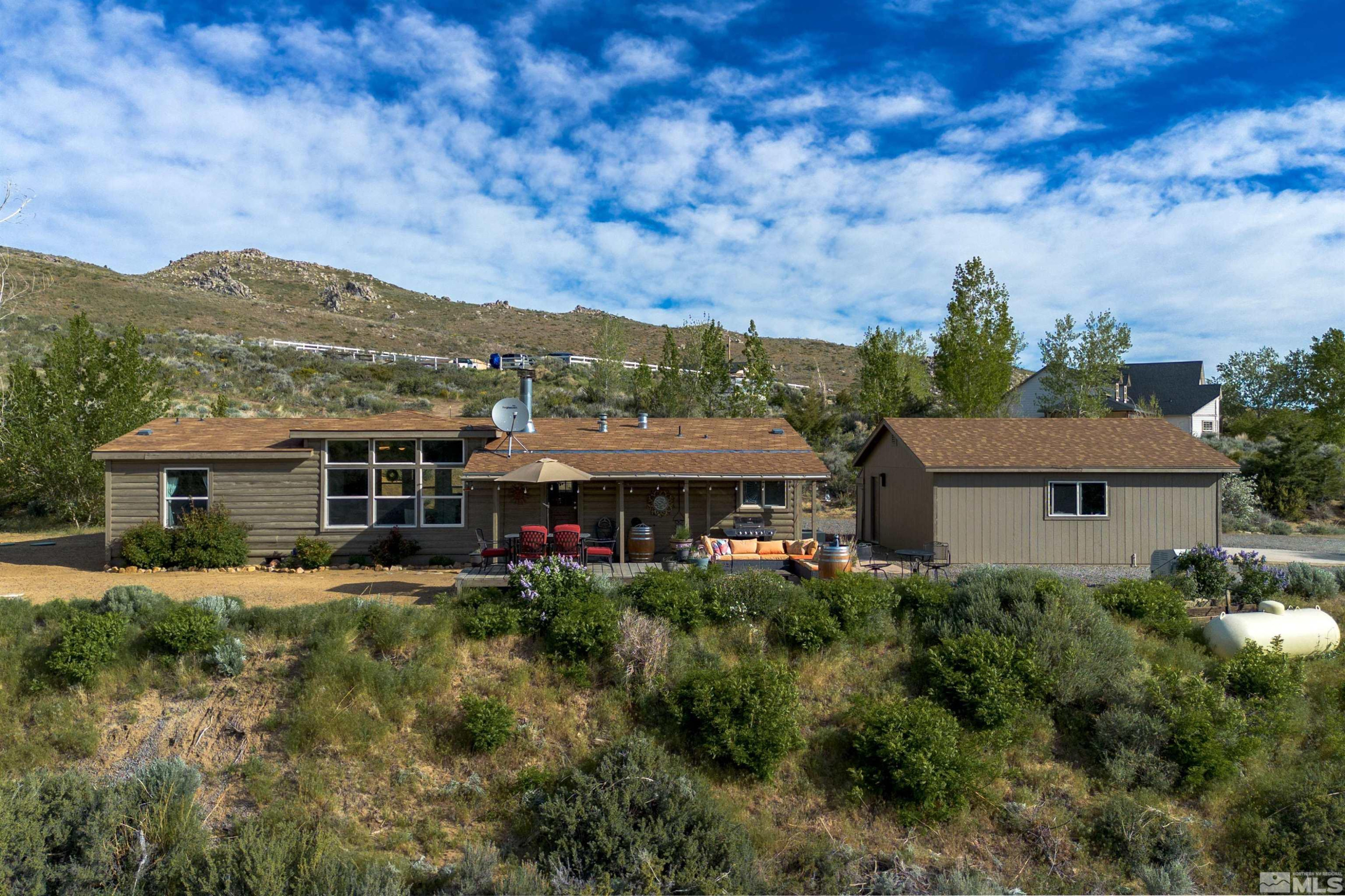 13705 North Red Rock Road Reno, NV 89508 - Photo 2 of 46 a view of a big house with a big yard plants and large trees