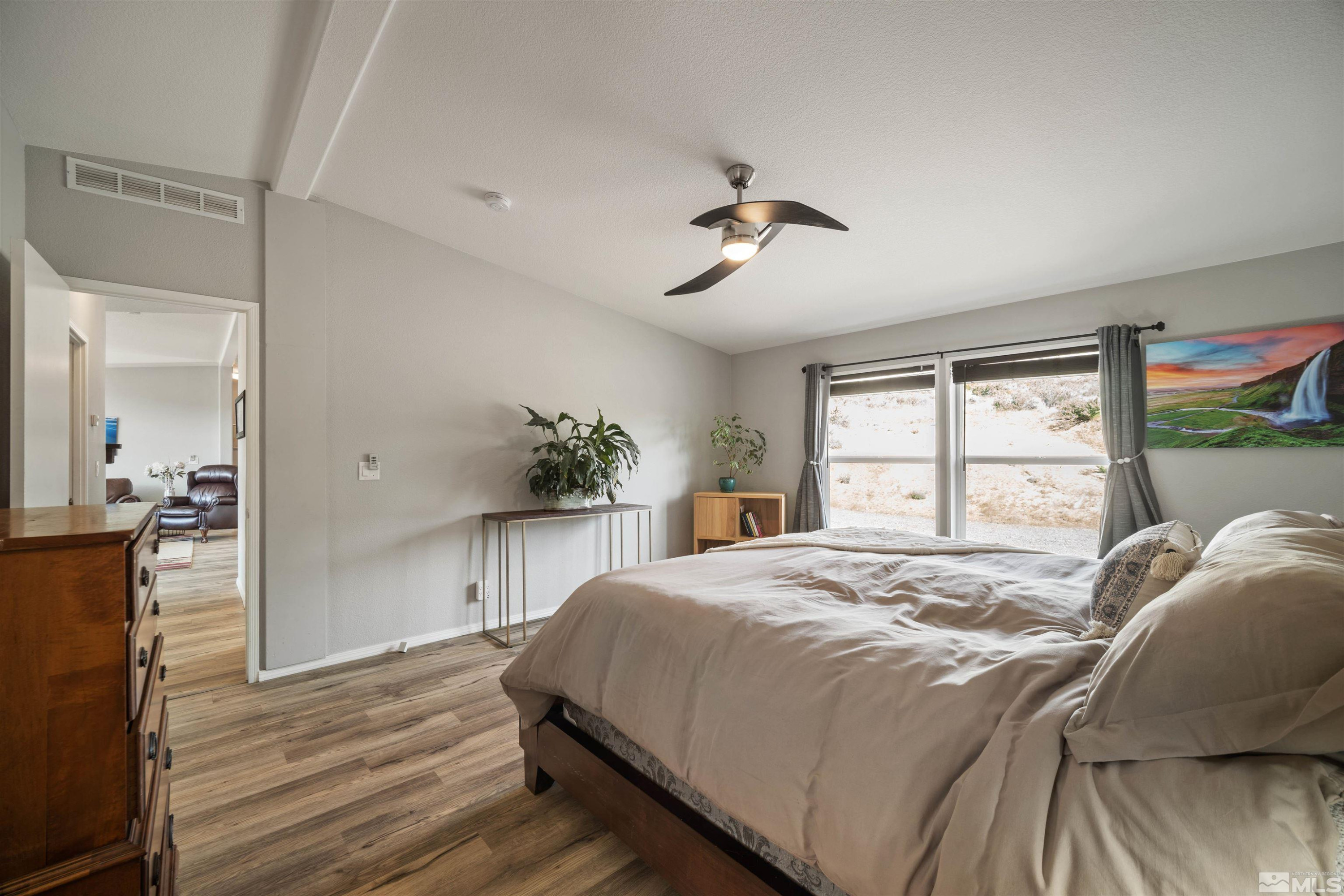 13705 North Red Rock Road Reno, NV 89508 - Photo 21 of 46 a bedroom with a bed and a window