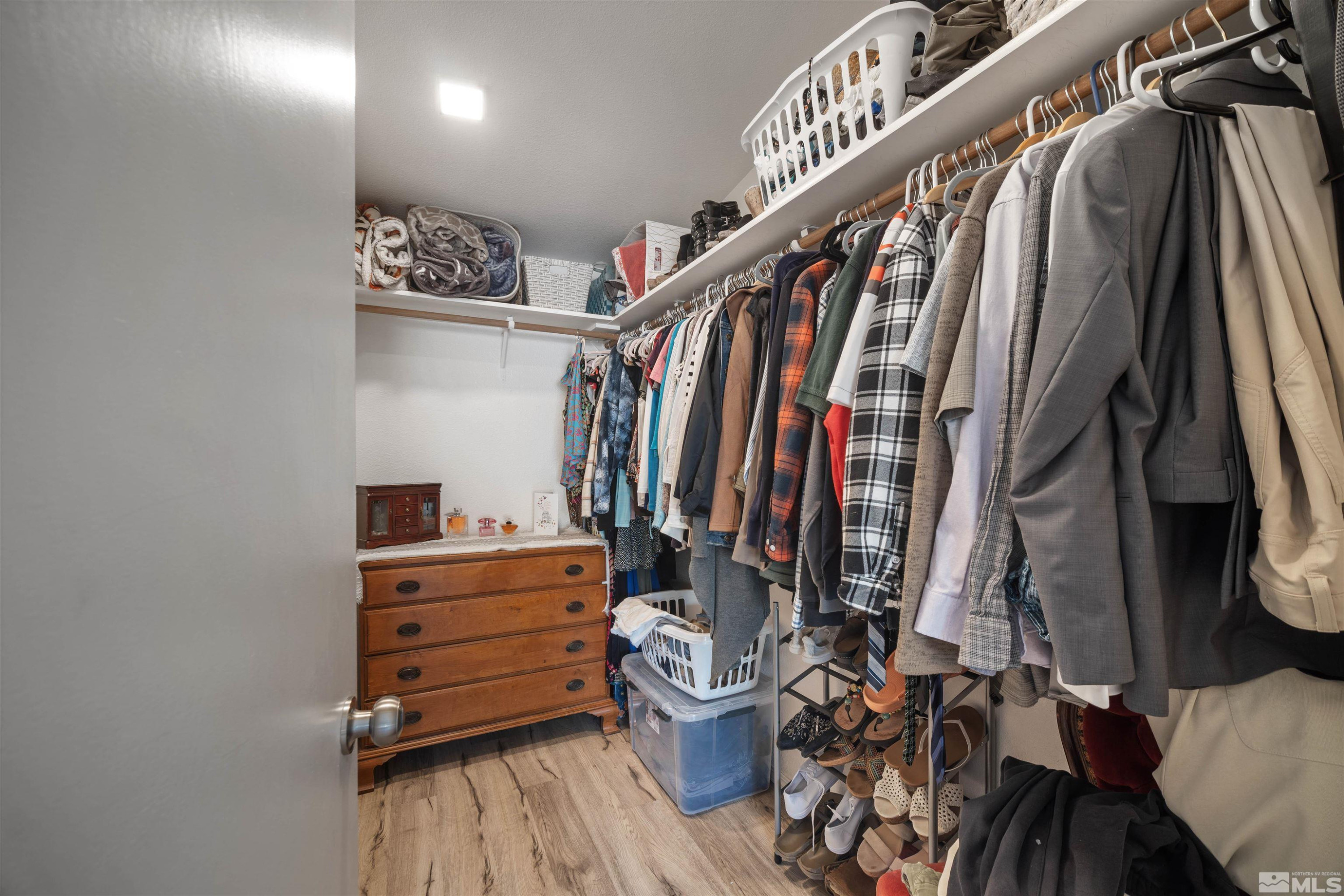 13705 North Red Rock Road Reno, NV 89508 - Photo 22 of 46 a view of walk in closet with clothes and shoes