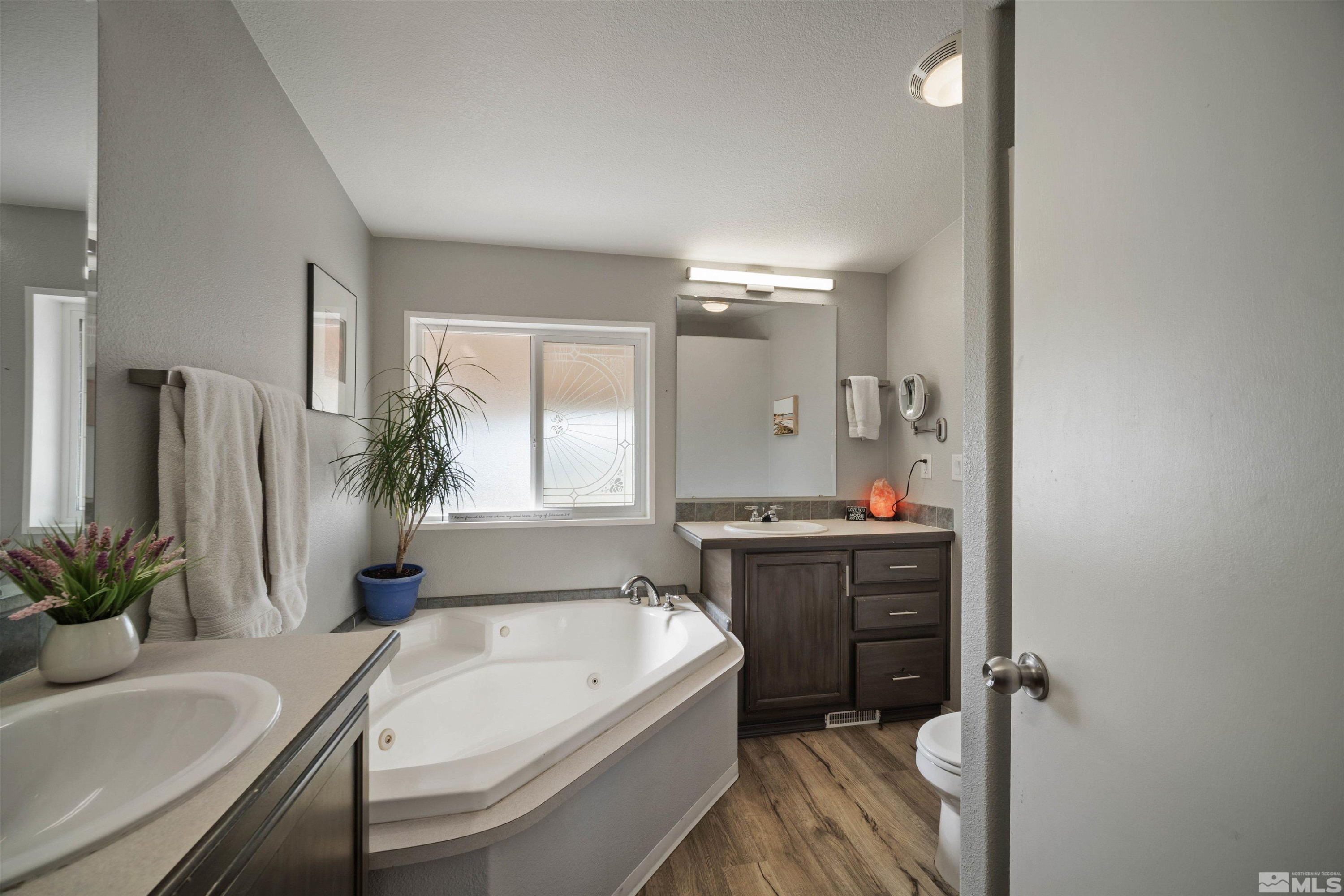 13705 North Red Rock Road Reno, NV 89508 - Photo 23 of 46 a spacious bathroom with a tub sink and mirror