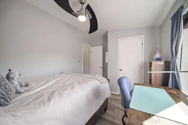 a bedroom with a bed and a chair