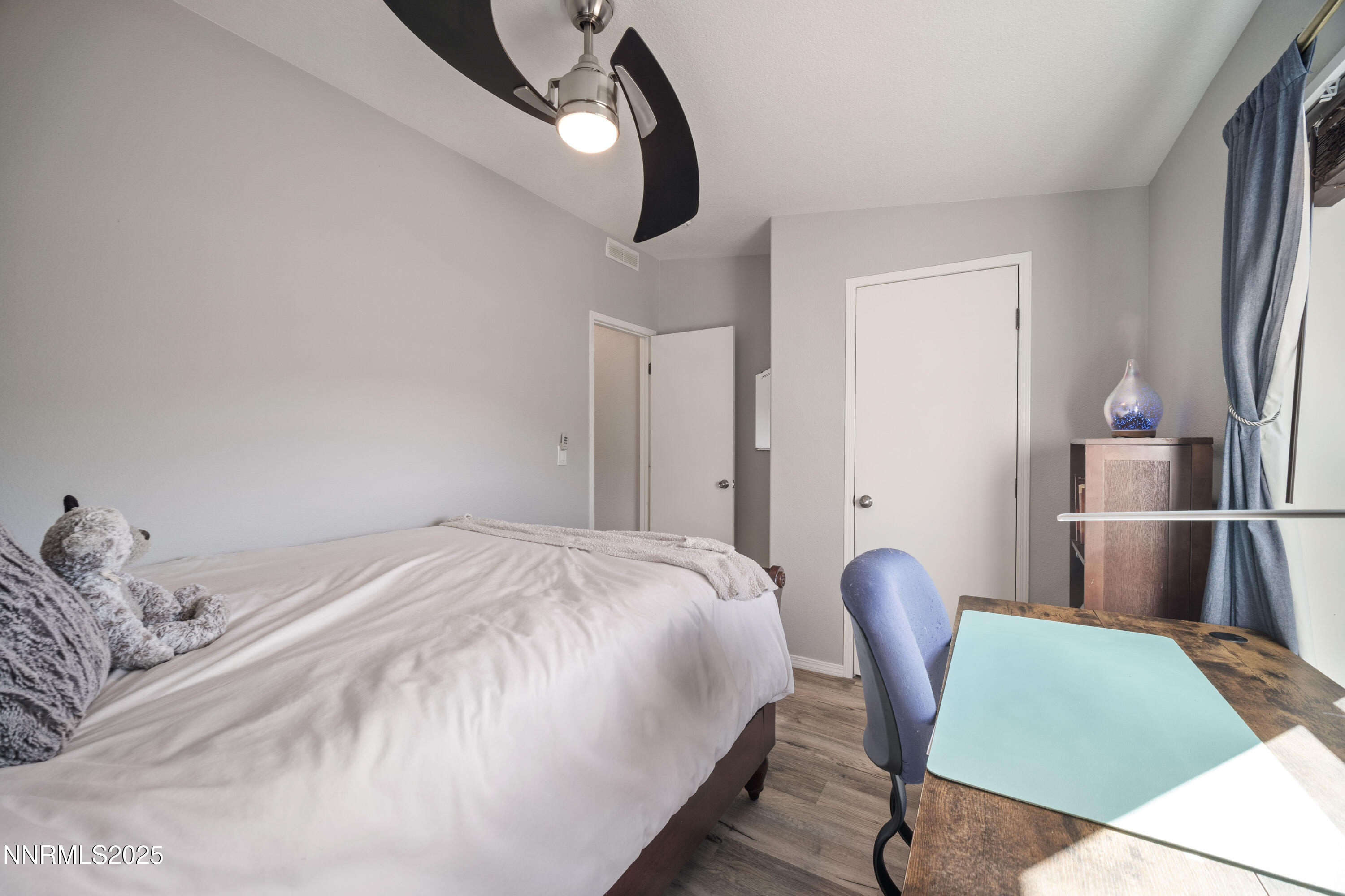 13705 North Red Rock Road Reno, NV 89508 - Photo 28 of 46 a bedroom with a bed and a chair