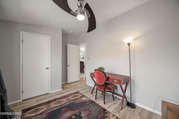 a view of a room with furniture and wooden floor
