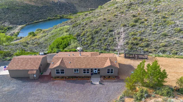 an aerial view of a house with yard and outdoor seating
