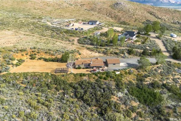 a view of a backyard with a patio and outdoor seating