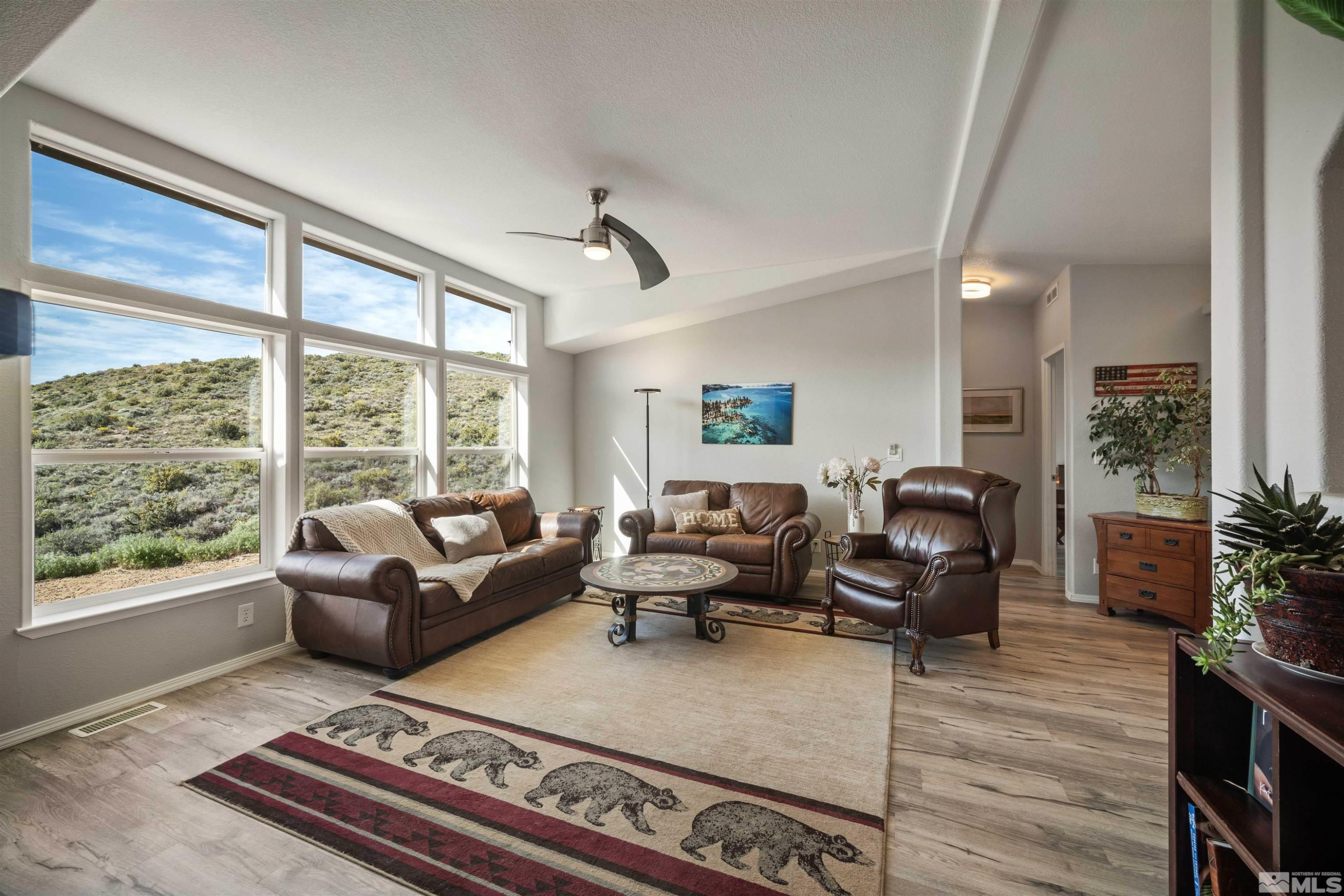 13705 North Red Rock Road Reno, NV 89508 - Photo 10 of 46 a living room with furniture large window and flat screen tv
