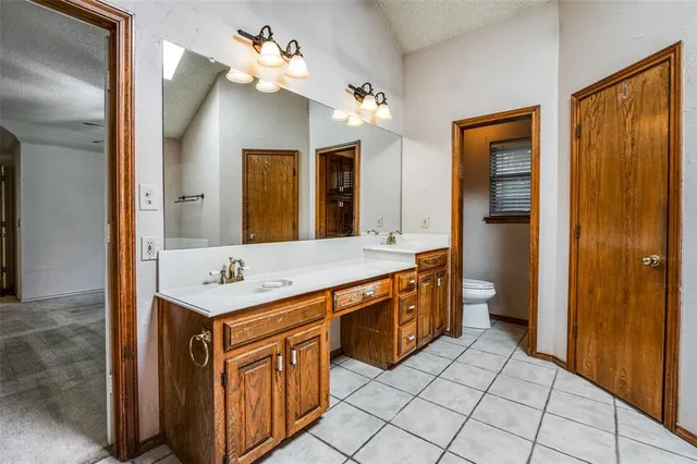 a spacious bathroom with a double vanity sink a mirror and a shower