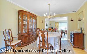 18 Dale Road Middletown, NJ 07748 - Photo 11 of 48 a view of a dining room with furniture and chandelier