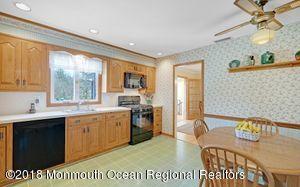 18 Dale Road Middletown, NJ 07748 - Photo 13 of 48 a open kitchen with stainless steel appliances granite countertop a sink a stove and a refrigerator