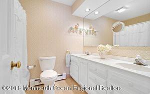 18 Dale Road Middletown, NJ 07748 - Photo 28 of 48 a bathroom with a toilet a sink and mirror