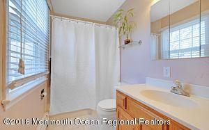 18 Dale Road Middletown, NJ 07748 - Photo 29 of 48 a bathroom with a sink a toilet and a shower curtain