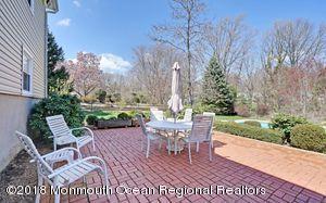 18 Dale Road Middletown, NJ 07748 - Photo 32 of 48 a view of a patio with table and chairs and potted plants