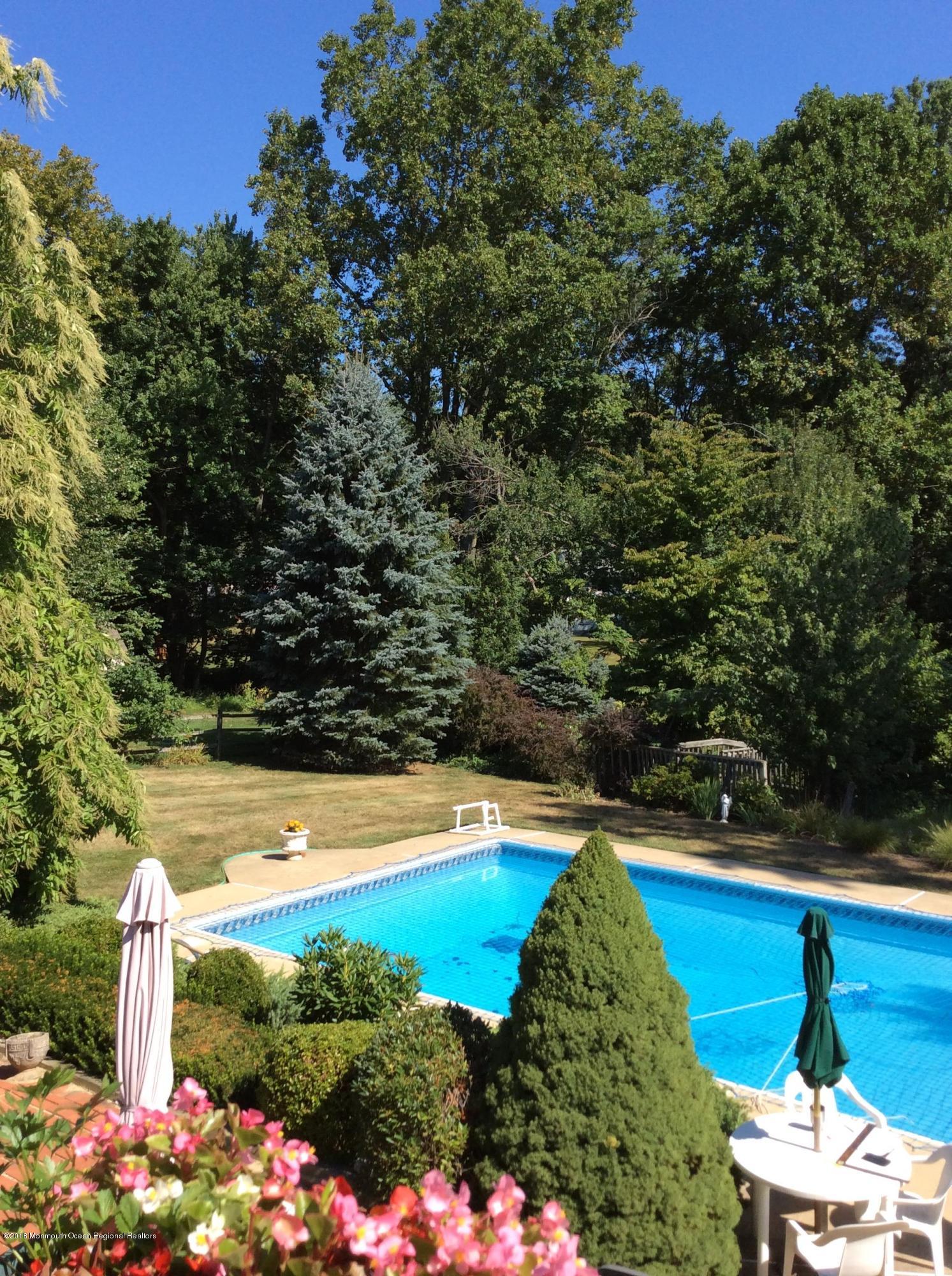 18 Dale Road Middletown, NJ 07748 - Photo 40 of 48 a view of a swimming pool with an outdoor space and seating area