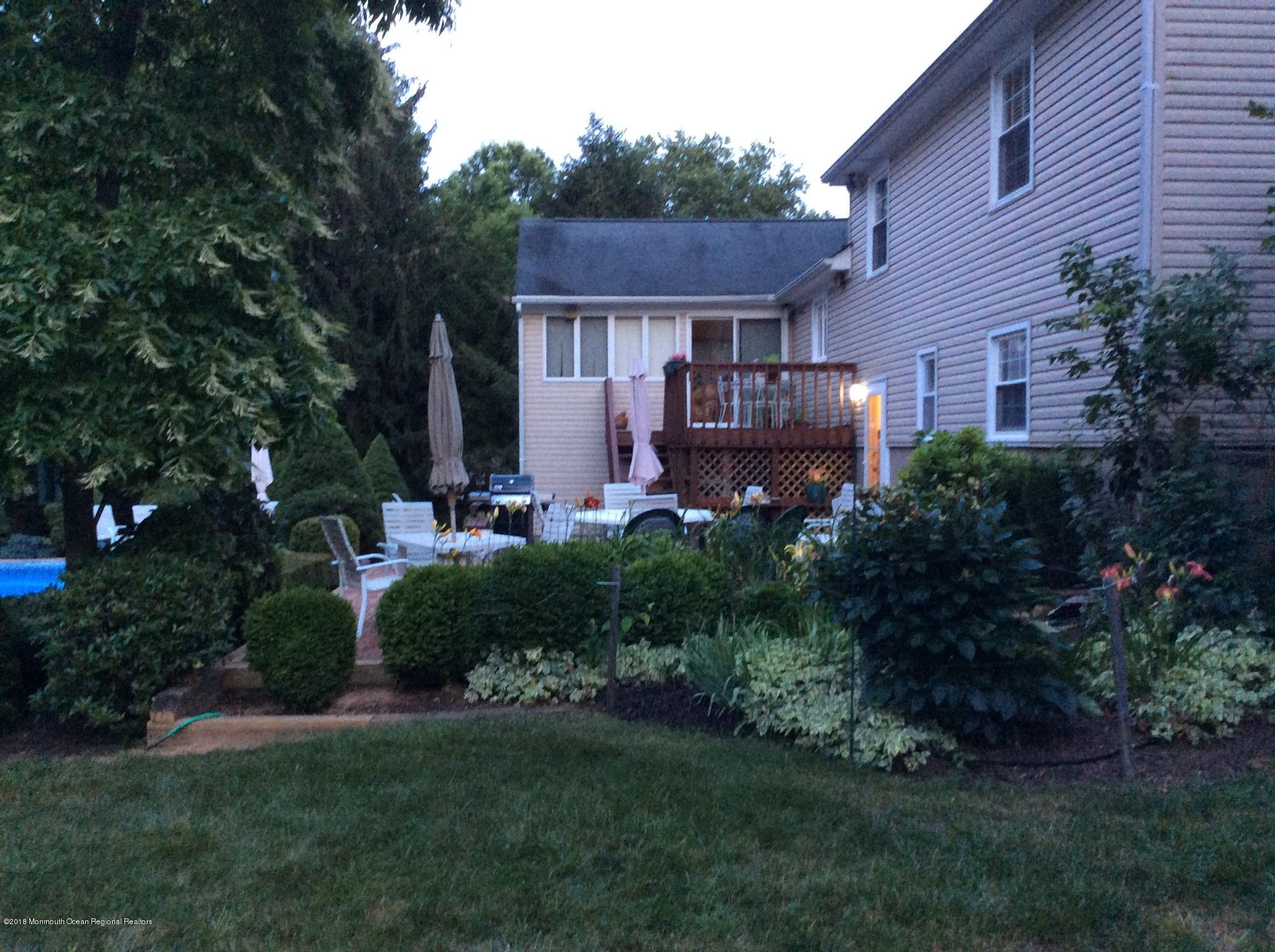 18 Dale Road Middletown, NJ 07748 - Photo 46 of 48 a front view of a house with a garden