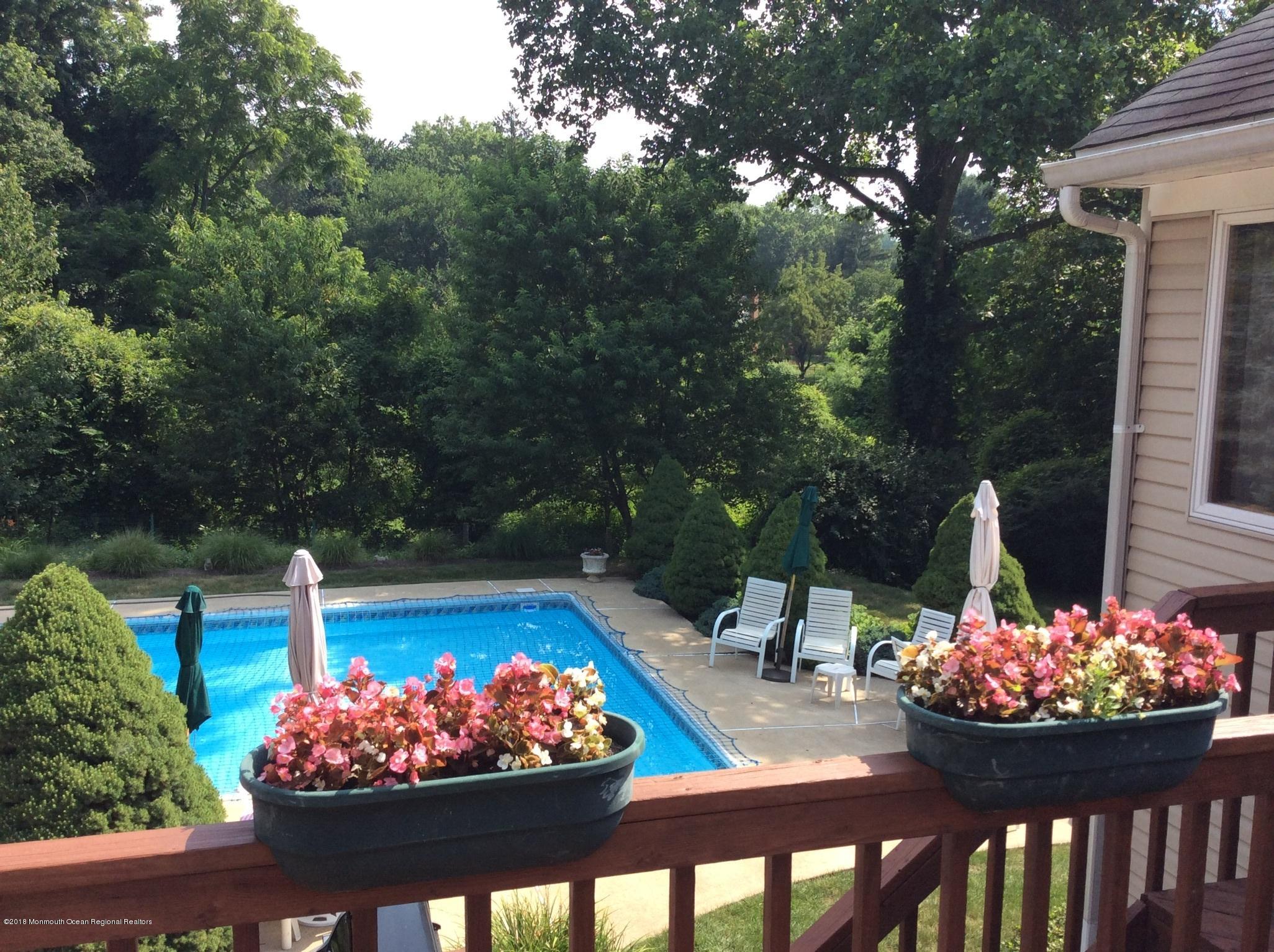 18 Dale Road Middletown, NJ 07748 - Photo 47 of 48 a view of a chairs and table in a patio