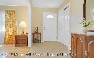 18 Dale Road Middletown, NJ 07748 - Photo 7 of 48 a living room with a fireplace furniture and a chandelier