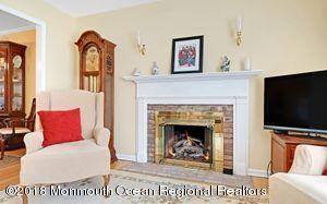 18 Dale Road Middletown, NJ 07748 - Photo 10 of 48 a living room with furniture a flat screen tv and a fireplace